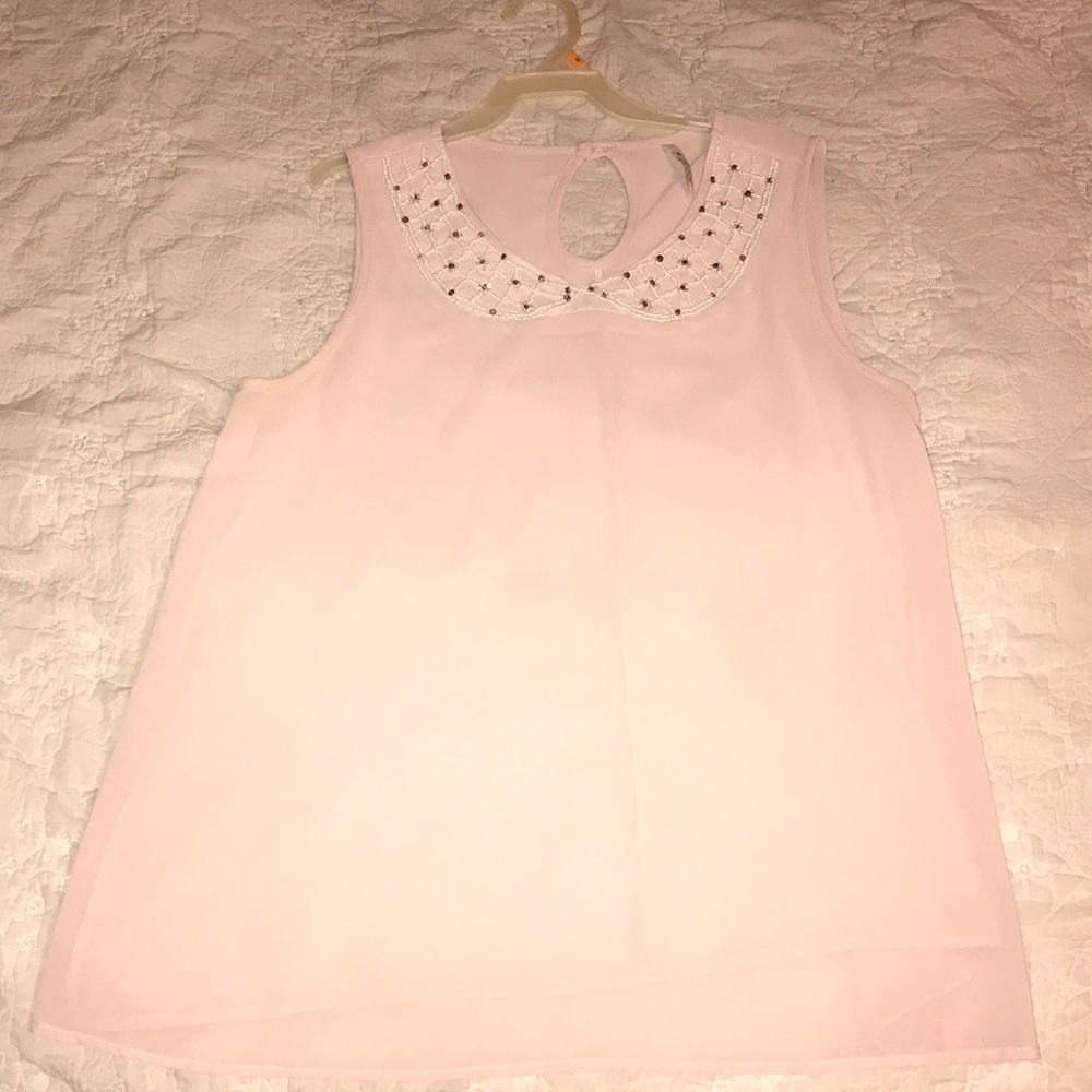 Light pink shirt with sequins.
